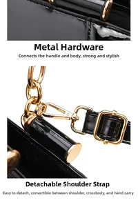 Detail of glossy black patent leather bag with gold hardware and removable chain strap