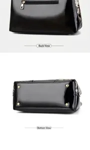 Detail view of black patent leather bag featuring back zipper and protective bottom studs