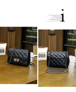 Detail of black quilted chain bag with silver studs and metal twist-lock closure