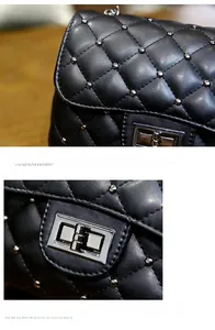 Detail of black quilted shoulder bag featuring silver rivets and a metal twist lock closure