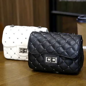 Quilted crossbody bag with metal studs and chain strap in classic black and white