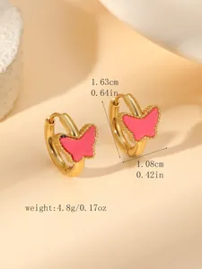 Détail de boucles d'oreilles créoles dorées avec papillon rose et dimensions précises