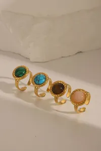 Detailed macro view of four vintage gold rope rings with colorful turquoise inlays