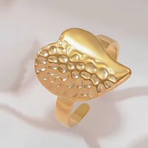 Detailed view of 18k gold plated stainless steel ring with hammered and smooth texture