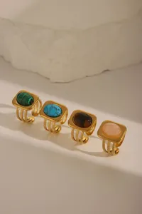 Detailed view of vintage 18K gold plated rings set with turquoise and colorful gemstones