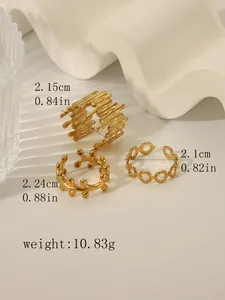 Detailed view of three 18k gold plated stainless steel rings with lava texture and cutouts
