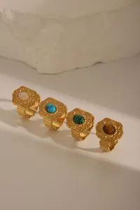Detailed view of four vintage 18K gold plated stainless steel rings with colorful stones