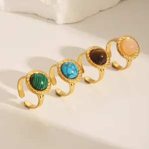 Detailed view of four 18K gold plated adjustable rings with colorful gemstone inlays