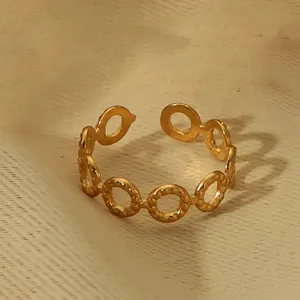 Detail of 18k gold plated open ring featuring beaded edge texture and hollow circular design