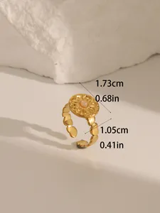 Close-up of 18k gold plated ring featuring a turquoise inlay and heart-shaped band details