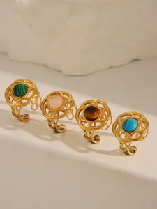 Detail of four vintage 18k gold plated adjustable rings with turquoise and colorful stones