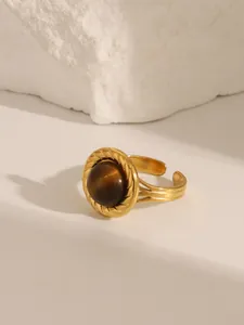 Detail of vintage 18K gold plated ring with round turquoise inlay on white stone