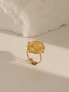 Macro detail of 18K gold plated ring with turquoise and sunburst texture on stone