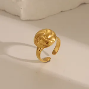 Macro detail of gold croissant dome ring with vintage spiral texture on stone base