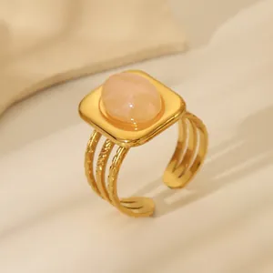 Detail of 18k gold plated stainless steel ring featuring a pink oval gemstone