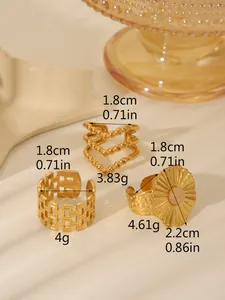 Detailed view of three 18k gold-plated rings including a pink sunburst gem and hollow bands