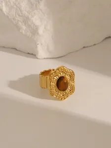 Detailed view of 18K gold plated ring with vintage engraved texture and brown tiger eye stone
