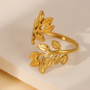 Detailed macro shot of an 18k gold plated leaf wrap ring on a stone pedestal