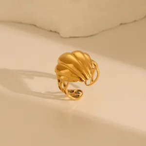 Close-up of golden textured dome ring with radial pattern and side hollow details