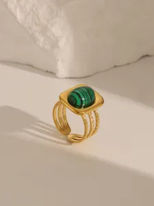 Detailed view of an 18K gold-plated ring with a round green turquoise stone inlay