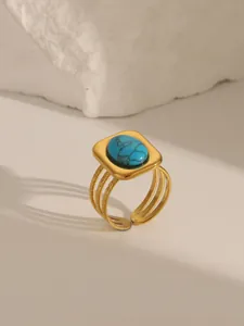 Detail of 18K gold plated stainless steel ring with turquoise inlay and triple-layer band