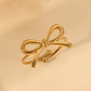 Detailed close-up of 18k gold plated stainless steel bow ring on elegant background