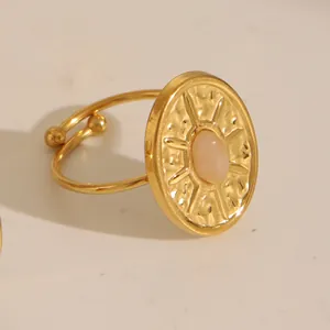 Macro detail of 18k gold plated sunburst ring featuring a pink turquoise oval gemstone