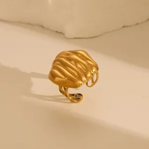 Detailed view of gold textured open ring with flowing lava-style organic patterns