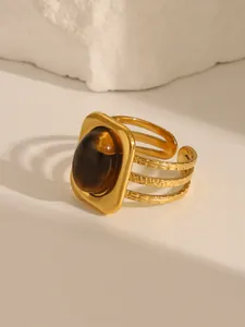Macro shot of 18K gold plated geometric ring with oval turquoise stone inlay