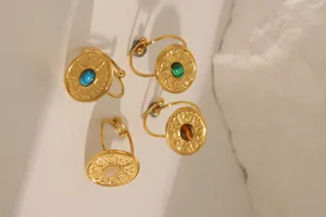 Close-up of vintage 18k gold plated rings with colorful turquoise and gemstone inlays
