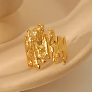 Macro shot of gold textured ring with lava surface on beige ceramic background