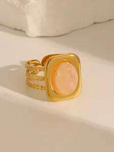 Close-up of vintage 18K gold plated ring with pink turquoise and textured triple bands