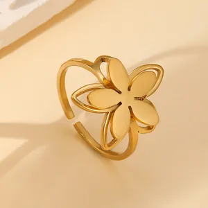 Detailed close-up of 18k gold plated stainless steel floral ring with open band design