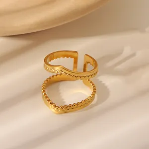 Detail of double-layer golden heart ring with micro-beaded texture and open adjustable design