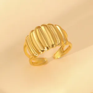 Macro detail of 18k gold plated croissant ring with elegant vertical textured design