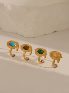 Macro view of four 18k gold plated open rings with turquoise and colorful gemstones