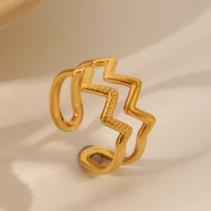 Macro shot of gold-plated double-layer wavy ring with textured and polished finish