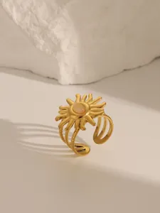 Macro shot of gold plated geometric sunburst ring featuring an oval center gemstone