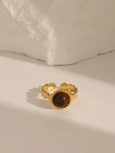 Detail of 18K gold plated stainless steel ring with turquoise stone and heart engraving