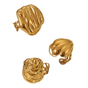 Three-piece set of textured gold stainless steel rings with organic relief designs