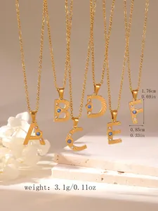 Detailed view of gold letter pendants with blue zircon and radial textures, size 1.76cm