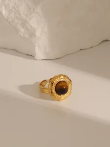 Macro detail of vintage 18K gold plated ring with round tiger eye stone inlay