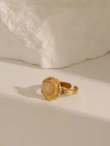 Macro detail of 18K gold plated ring featuring pink stone inlay and adjustable band