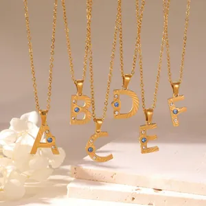 Gold stainless steel alphabet necklaces with cubic zirconia and blue center stones