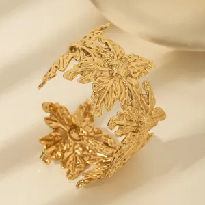 Detailed view of leaf shaped open cuff bracelet with hammered texture in gold finish