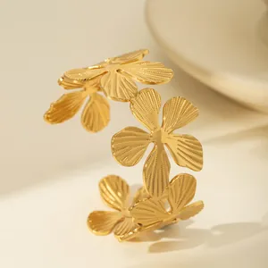Close-up of golden hammered flower cuff bracelet with intricate petal textures