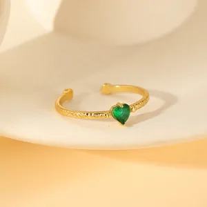 Adjustable gold plated hammered ring featuring a heart shaped green zircon gemstone