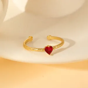 Adjustable gold plated copper ring with red heart zircon and hammered texture surface