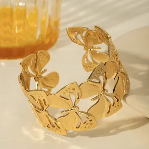 Detailed view of a gold-plated butterfly cuff bracelet with intricate hollow wing details