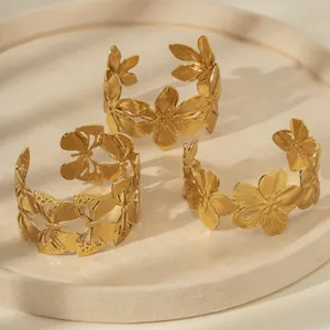 Three-piece gold hammered bangle set with hollow butterfly and floral motifs in matte finish